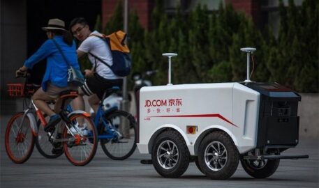 zwei Fahrradfahrer und ein JD.com Lieferroboter