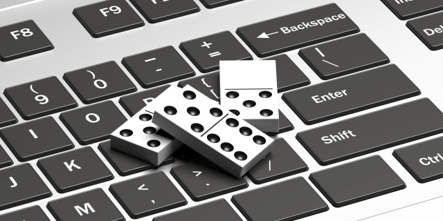 Dominoes game online. Domino tiles on a computer laptop